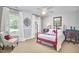 Comfortable bedroom featuring large windows, a ceiling fan, and neutral carpeting at 18 Clearwater Dr, Durham, NC 27707