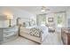 Bright and airy bedroom features a large bed, neutral decor, and two large windows at 18 Clearwater Dr, Durham, NC 27707
