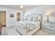 Bright bedroom boasts an upholstered headboard, and a view to the bathroom at 18 Clearwater Dr, Durham, NC 27707