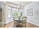 Cozy breakfast nook with a bay window, hardwood floors, and a round table with four chairs at 18 Clearwater Dr, Durham, NC 27707