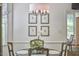 The breakfast nook has an abundance of natural light and botanical wall art at 18 Clearwater Dr, Durham, NC 27707