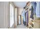 Walk-in closet with custom shelving, hanging rods, and a full-length mirror at 18 Clearwater Dr, Durham, NC 27707