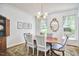 Dining room featuring a hardwood table with stylish chairs, decorative lighting and windows at 18 Clearwater Dr, Durham, NC 27707