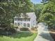Charming two-story home with a well-manicured front yard and a long driveway leading to a detached garage at 18 Clearwater Dr, Durham, NC 27707