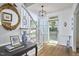 Bright foyer with hardwood floors, staircase, elegant mirror, and glass paneled front door at 18 Clearwater Dr, Durham, NC 27707