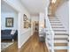 Hallway featuring hardwood floors, elegant decor and a staircase with white trim and wooden steps at 18 Clearwater Dr, Durham, NC 27707
