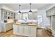 Kitchen featuring light green cabinets, butcher block island, modern appliances, and marble countertops at 18 Clearwater Dr, Durham, NC 27707