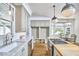 Bright kitchen features marble countertops, stainless steel appliances, and a breakfast nook with natural light at 18 Clearwater Dr, Durham, NC 27707
