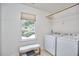 Functional laundry room with a window, washer, dryer, and storage space at 18 Clearwater Dr, Durham, NC 27707