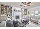 Bright living room boasts a fireplace, ceiling fan, and access to the outdoors at 18 Clearwater Dr, Durham, NC 27707