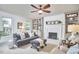 Inviting living room featuring a cozy fireplace, ceiling fan, and custom built-in bookshelves at 18 Clearwater Dr, Durham, NC 27707
