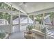 Relaxing screened-in porch with comfortable seating and views of the backyard and surrounding greenery at 18 Clearwater Dr, Durham, NC 27707