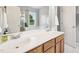 Bathroom featuring double sinks, and a separate tub behind mirrored shower doors at 1818 Misty Hollow Ln, Apex, NC 27502