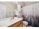 Bathroom featuring a white vanity, decorative shower curtain, and mirrored cabinet at 1818 Misty Hollow Ln, Apex, NC 27502