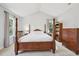 Bedroom with carpet flooring, a four-poster bed and ample natural light at 1818 Misty Hollow Ln, Apex, NC 27502