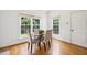 Bright breakfast nook with hardwood floors, two large windows, and a view of the backyard at 1818 Misty Hollow Ln, Apex, NC 27502