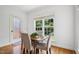 Bright breakfast nook with hardwood floors, large windows, and a view of the backyard at 1818 Misty Hollow Ln, Apex, NC 27502
