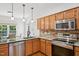 Bright kitchen features updated stainless steel appliances, breakfast area, and modern faucet at 1818 Misty Hollow Ln, Apex, NC 27502