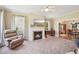 Cozy living room with fireplace, large window, and view to the dining room at 1818 Misty Hollow Ln, Apex, NC 27502