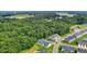 Aerial view of new townhome community bordered by mature trees at 1891 Frost Dr, Haw River, NC 27258