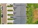 Aerial view of townhomes showing roof lines, driveways, and well manicured lawns at 1891 Frost Dr, Haw River, NC 27258