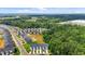 Aerial view of new townhome community surrounded by lush green forest and blue sky at 1891 Frost Dr, Haw River, NC 27258