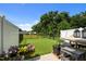 Well maintained fenced backyard with fresh green grass, landscaping and outdoor furniture at 1891 Frost Dr, Haw River, NC 27258