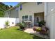 Cozy fenced backyard featuring green grass, potted plants, and outdoor dining set at 1891 Frost Dr, Haw River, NC 27258