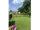 Spacious, green backyard features a black metal fence adorned with colorful flower boxes at 1891 Frost Dr, Haw River, NC 27258