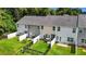 A row of townhomes showcasing well-maintained, fenced backyards with lush lawns and cozy patio setups at 1891 Frost Dr, Haw River, NC 27258