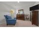 Serene bedroom with a comfortable chair, dresser, and ample natural light at 1891 Frost Dr, Haw River, NC 27258
