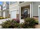 Home exterior boasts well-manicured landscaping, a garage, and a covered front entry at 1891 Frost Dr, Haw River, NC 27258