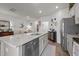 Open kitchen with granite countertops, stainless steel appliances, and views into the living room at 1891 Frost Dr, Haw River, NC 27258