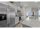 Well-lit kitchen with stainless appliances, granite countertops, and convenient access to the patio at 1891 Frost Dr, Haw River, NC 27258