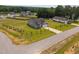 Aerial view of a gray, single-story home on a large lot in a neighborhood surrounded by trees at 19 Linda Lou Ln # 19, Angier, NC 27501