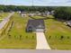Aerial view of a gray, single-story home on a large lot in a neighborhood surrounded by trees at 19 Linda Lou Ln # 19, Angier, NC 27501