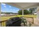 Cozy back porch with grill, chairs, and view of large grassy yard at 19 Linda Lou Ln # 19, Angier, NC 27501