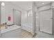 Bright bathroom with a tub, enclosed shower and single sink at 19 Linda Lou Ln # 19, Angier, NC 27501