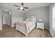 Bedroom showcasing a ceiling fan, wood flooring, and a nightstand with a lamp at 19 Linda Lou Ln # 19, Angier, NC 27501