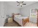 Cozy bedroom with a wooden bed frame, neutral bedding, and a bright window with blinds at 19 Linda Lou Ln # 19, Angier, NC 27501