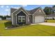Charming single-story home with gray siding, a two-car garage and a well-manicured lawn with flower beds at 19 Linda Lou Ln # 19, Angier, NC 27501