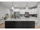 Kitchen island featuring granite countertops, a stainless steel sink, and ample storage space at 19 Linda Lou Ln # 19, Angier, NC 27501