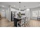 Modern kitchen island with granite countertops, stylish pendant lighting and barstool seating at 19 Linda Lou Ln # 19, Angier, NC 27501