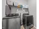 Efficient laundry room with modern washer and dryer units, with ample storage space on shelving at 19 Linda Lou Ln # 19, Angier, NC 27501