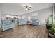 Spacious living room with light wood floors and comfortable blue couches adjacent to the open kitchen at 19 Linda Lou Ln # 19, Angier, NC 27501
