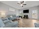 Spacious living room with light wood floors, a ceiling fan, a fireplace and comfortable blue couches at 19 Linda Lou Ln # 19, Angier, NC 27501