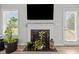 Close up of the fireplace in the living room with light wood floors and a flat screen TV mounted above at 19 Linda Lou Ln # 19, Angier, NC 27501