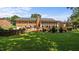 Expansive backyard with brick house, large screened in patio, and well-maintained lawn at 1926 Downing Dr, Burlington, NC 27215
