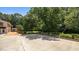 Wide angle view of the concrete patio and manicured landscape including mature shade trees at 1926 Downing Dr, Burlington, NC 27215
