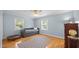 Cozy bedroom with hardwood floors, neutral paint, and natural light at 1926 Downing Dr, Burlington, NC 27215